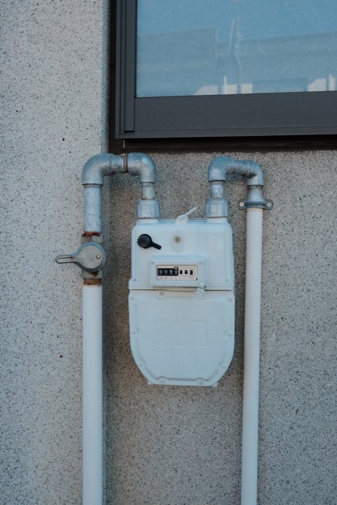 Close-up of an industrial gas meter on a concrete wall in Inuyama, Japan.